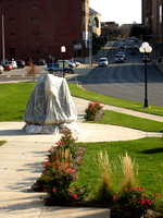 The sculpture was installed in early October 2010 in Lincoln Park next to the Bloomington Center for the Performing Arts. The figures and the base were draped in silk parachutes prior to the unveiling